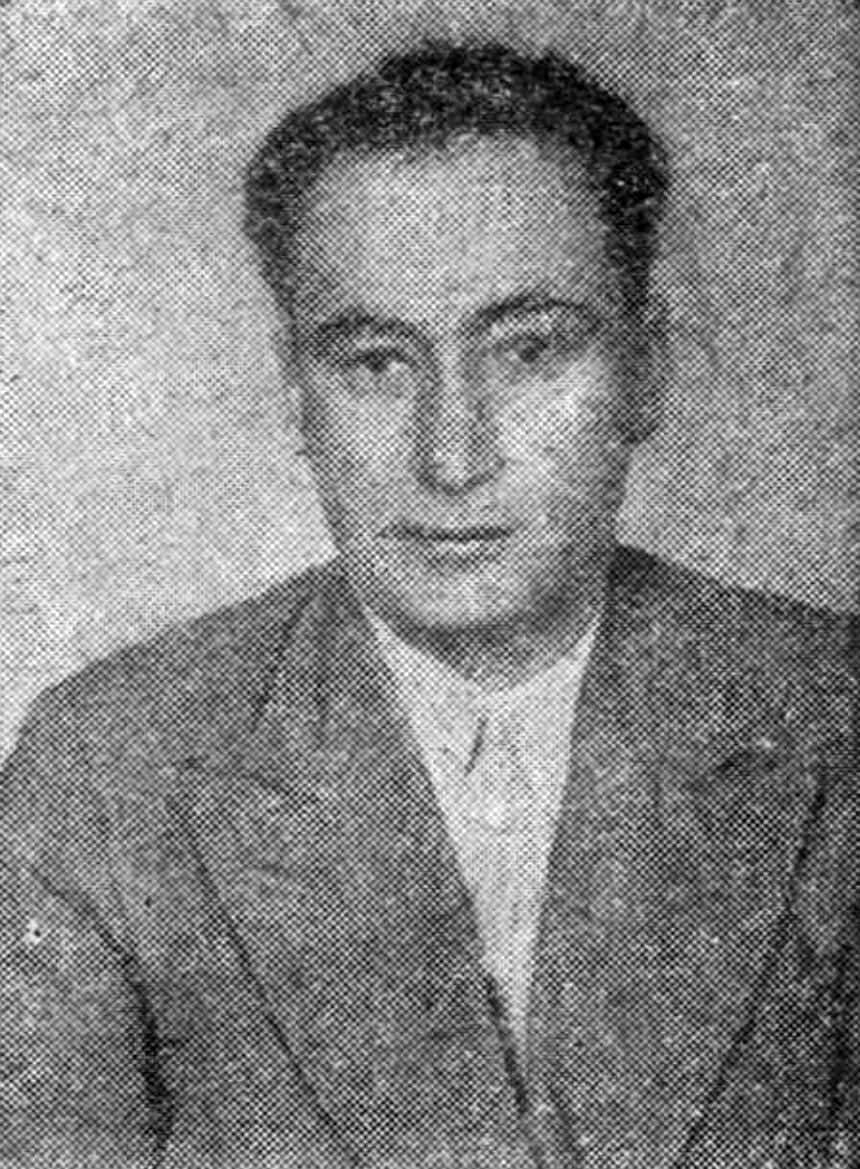 Black and white portrait of a man in a dark jacket looking slightly away from the camera