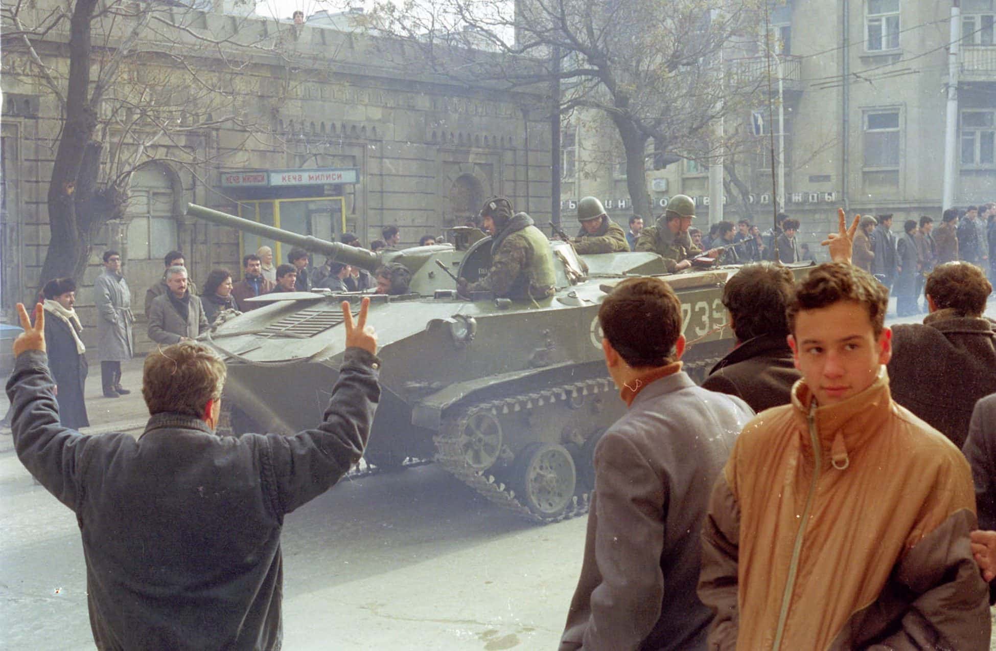 Soviet soldiers standing on and around an armoured vehicle on a Baku street in winter 1990