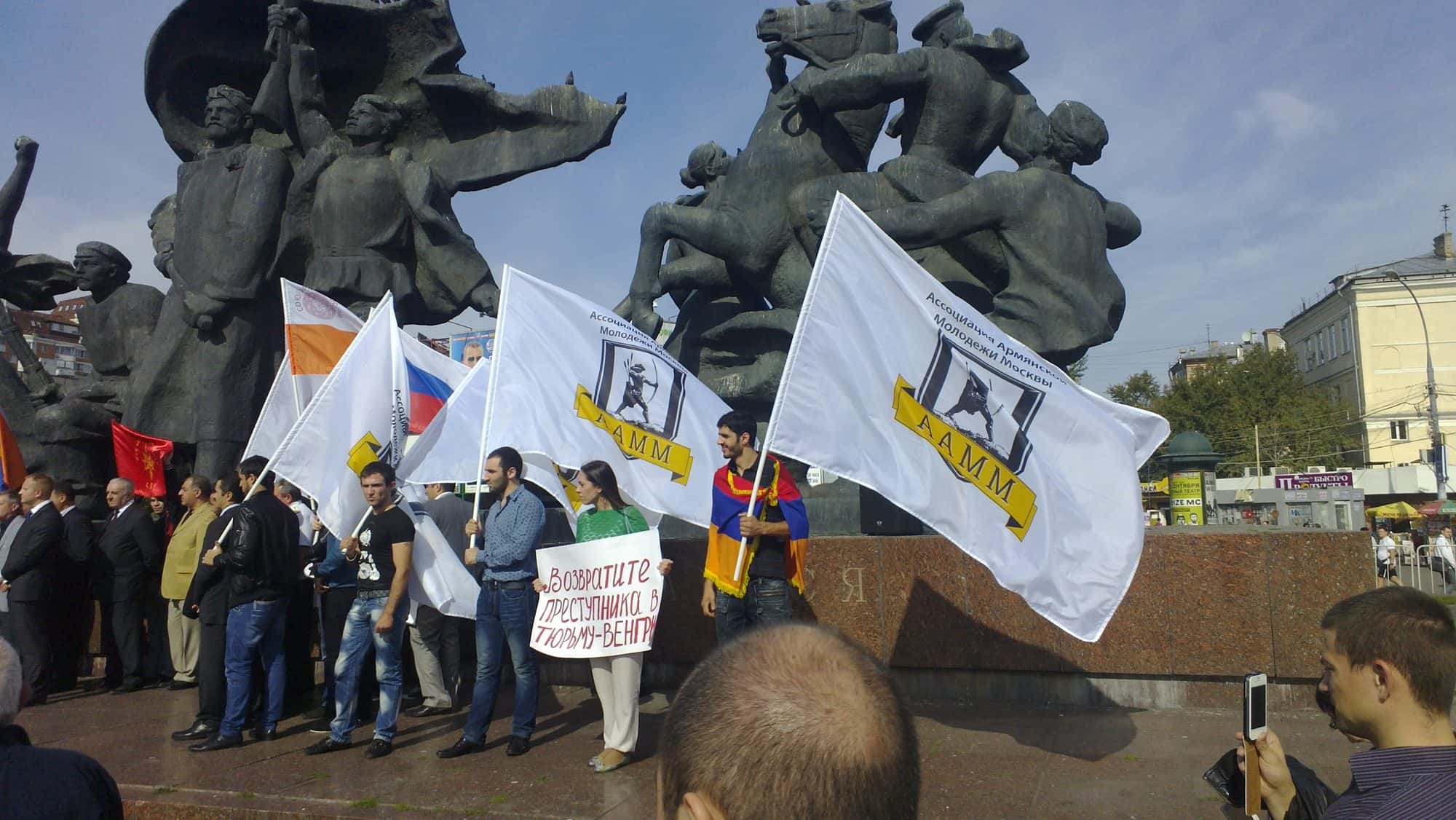 Crowd of demonstrators holding banners and placards at a street protest in Moscow