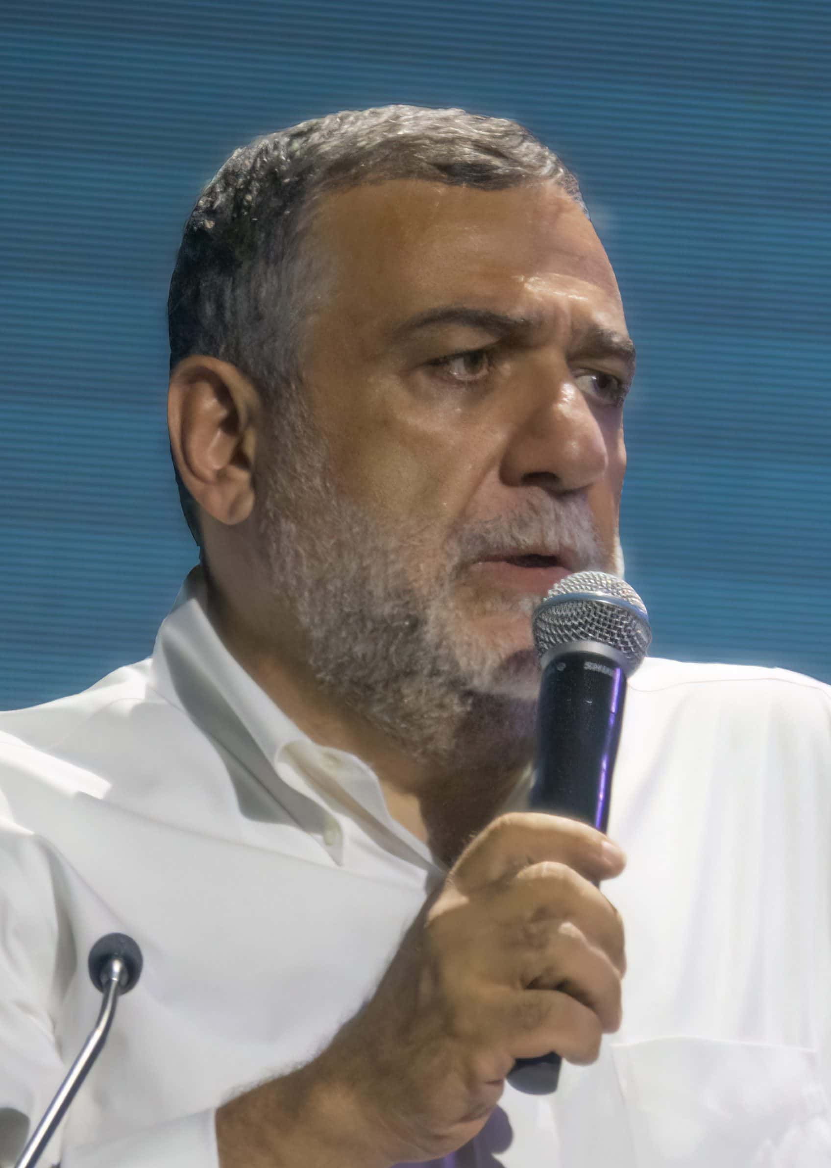 Ruben Vardanyan in a dark jacket at a public forum, looking toward the camera