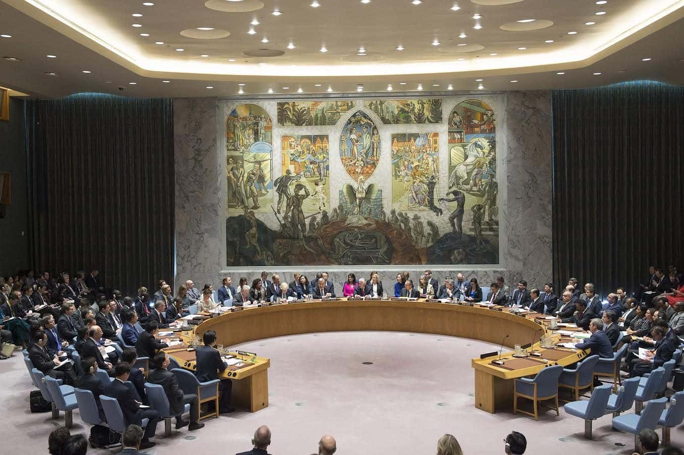 Delegates seated around the horseshoe table of the Security Council chamber