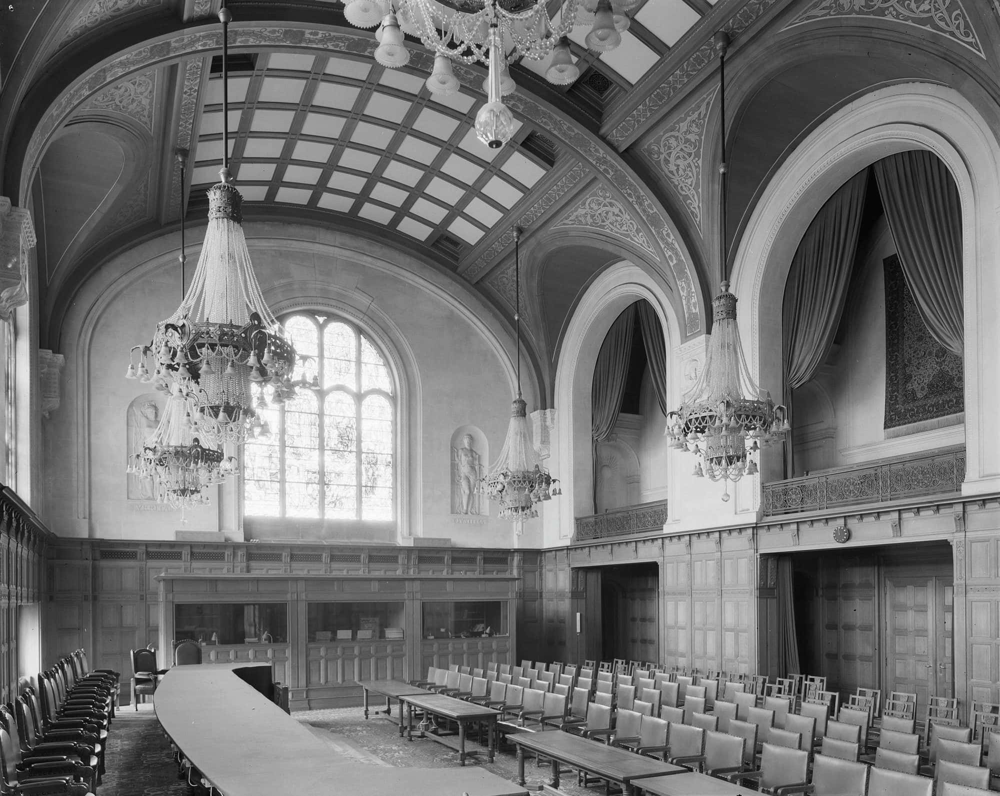 Wide view of the Great Hall of Justice showing the empty judges' bench, the wooden panelling and the tall stained glass window