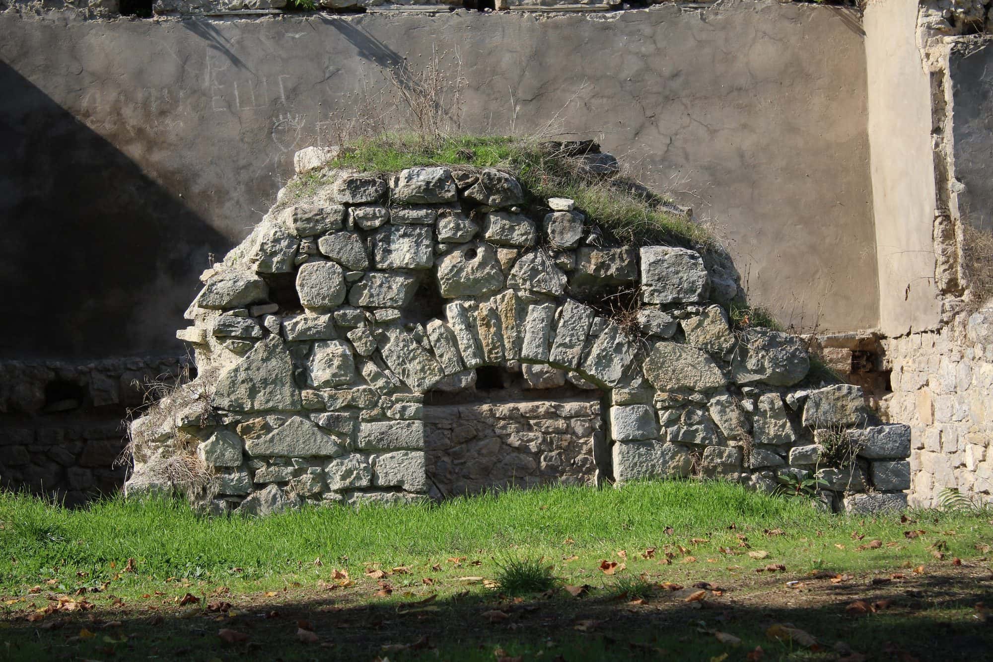 Stone facade of the eighteenth century melik palace at Togh, with arched doorways and dressed masonry